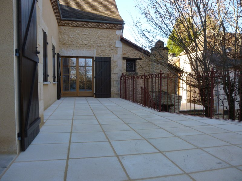 Rear terrace is paved and railings fabricated and installed.
